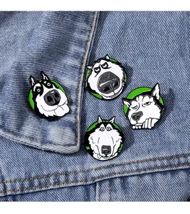 Close-up of four funny husky enamel pins attached to a blue denim jacket pocket