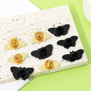 Back view of butterfly and moth pins in gold and black with butterfly clasp closure