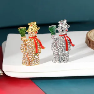 Sparkling snowman brooches with crystals and colorful enamel in gold and silver finish