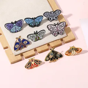 Enamel butterfly and moth pins set featuring moon patterns and diverse gender pronouns