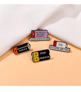 Detail view of enamel social battery pins showing creative zinc alloy lacquer textures