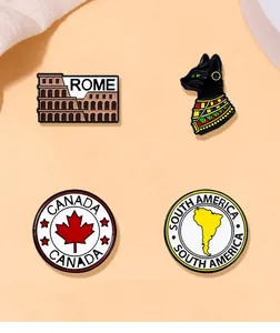 Detail view of four enamel pins including Rome, Canada, South America and Egyptian Cat motifs