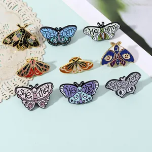 Macro detail of nine colorful enamel butterfly pins with gender identity pronouns design