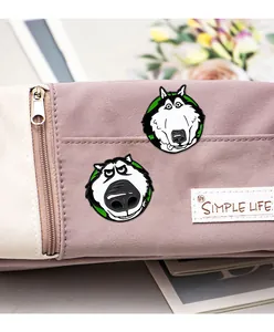 Close-up of cute husky enamel pins attached to a purple canvas pencil case as accessories