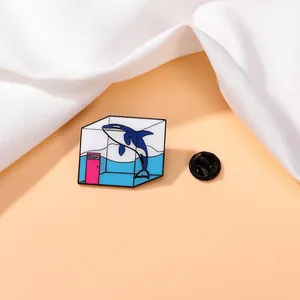 Detailed close-up of a blue whale enamel pin in a glass cube with ROOM text detail