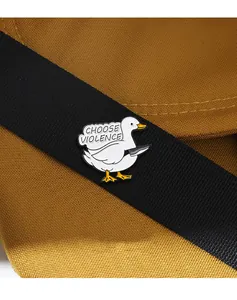 Macro detail of cartoon duck enamel pin with Choose Violence text on a black strap