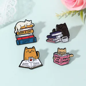 Detail of colorful enamel lapel pins featuring cartoon cats with books and coffee motifs