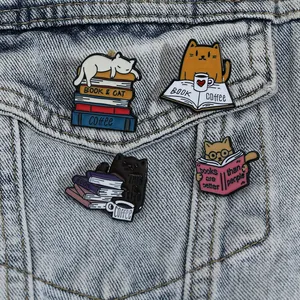 Set of 4 cute cartoon cat enamel pins featuring books and coffee on denim background