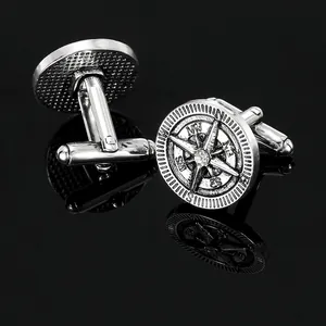 Vintage silver compass cufflinks for men featuring engraved directions and center gemstone