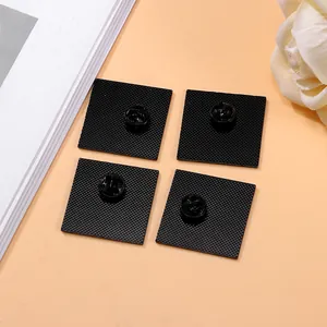 Set of four matte black square frog badges with butterfly clutches and non-slip texture