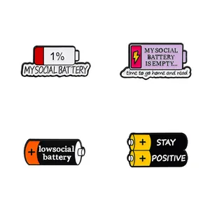 Set of four colorful battery enamel pins with social energy and stay positive slogans