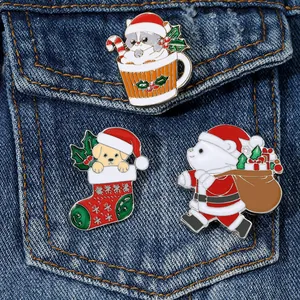 Three cute Christmas enamel pins featuring a cat, puppy, and bear on a denim jacket pocket