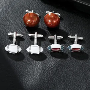 Macro detail of alloy sports cufflinks showing basketball and rugby ball designs on leather