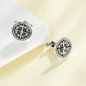 Close-up of vintage silver compass cufflinks for men with central crystal detail