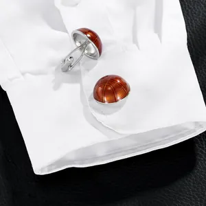 Men's basketball cufflinks on white shirt cuff with textured orange enamel and silver base
