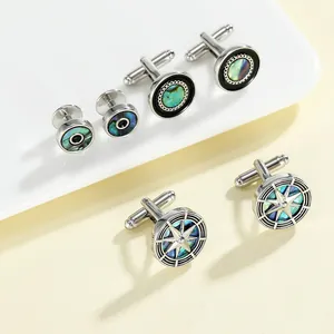 Macro detail of polished silver cufflinks set with iridescent abalone shell inlays