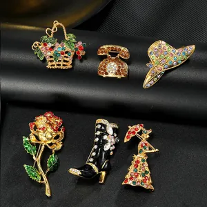Detailed view of vintage enamel brooches featuring flowers, boots and retro phone designs