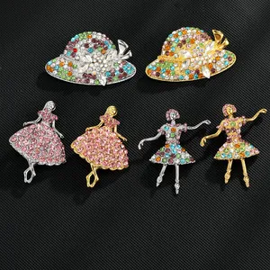 Detailed view of dancing girl brooches with colorful rhinestones and gold-tone finish