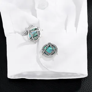 Classic silver Masonic cufflinks with abalone shell inlay on a white shirt cuff
