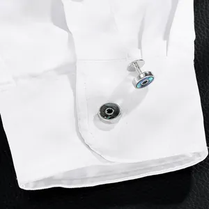 Detailed close-up of elegant silver cufflinks with dark iridescent shell inlay on shirt