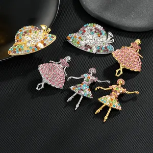 Detail view of colorful rhinestone-encrusted hat and ballet dancer brooches on black display