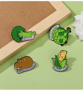Detail of creative enamel pins set featuring croccoli and hippotatomus animal designs