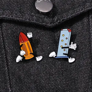 Macro detail of cartoon pen and pencil enamel pins running on black denim jacket pocket