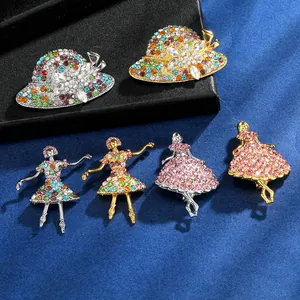 Detailed close-up of sparkling rhinestone dancing girl and sun hat brooches with alloy base