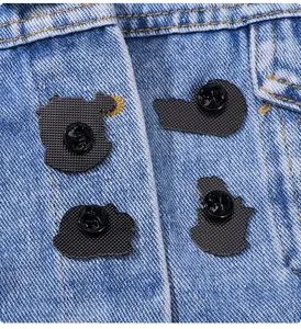 Detail of metal pin backs with rubber clutches on blue denim jacket fabric