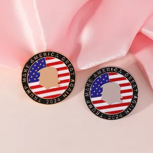 Close-up of gold and silver Trump 2024 enamel pins on soft pink silk background
