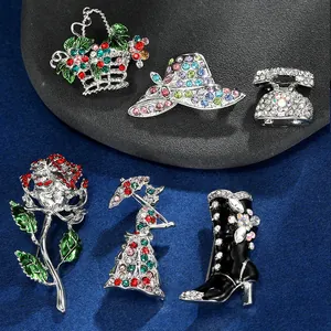 Set of six colorful enamel brooches with crystals featuring boots, hat, and flower basket