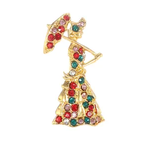 Elegant gold-tone lady with umbrella brooch featuring colorful crystal rhinestones