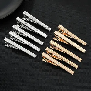 Macro detail of 10-piece metal tie clip set showing assorted textures and finishes