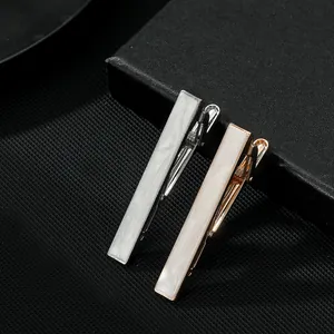 Classic silver and rose gold tie clips with mother of pearl inlay on black leather box