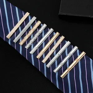 Set of 10 classic metal tie clips in gold and silver finishes on a striped navy tie