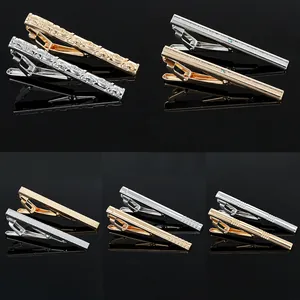 Macro detail of various gold and silver business tie clips with premium metal textures