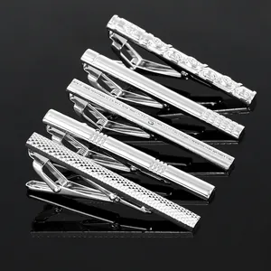 Detailed set of five silver metal necktie clips for men with various textured finishes