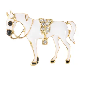 Elegant white enamel horse brooch with gold trim and sparkling rhinestones inlay