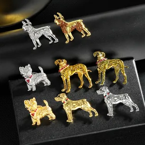 Huit broches chiots vintage plaquées or et argent ornées de strass colorés et de détails fins