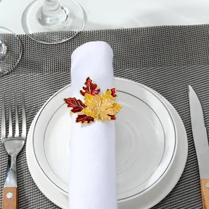 Macro detail of autumn maple leaf napkin ring with vibrant red and orange enamel finish