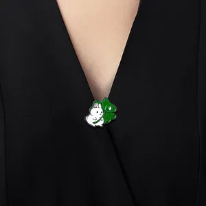 Cute white bunny enamel brooch with green four-leaf clover on black clothing lapel