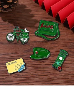 Close-up of retro Chinese post office enamel pins including vintage bicycle and mailbox