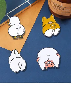 Close-up of enamel badges featuring cartoon corgi, duck, pig, and rabbit butts