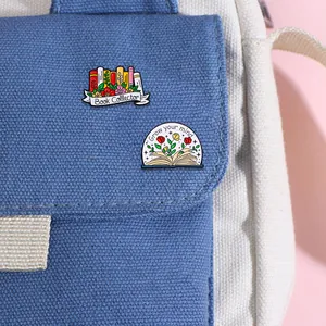 Cartoon enamel book pins featuring flowers and Grow Your Mind slogan on canvas bag