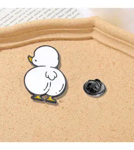 Detailed view of a cute cartoon white duck enamel pin with a metal butterfly clasp
