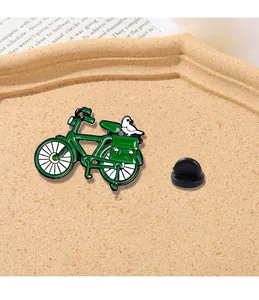 Macro detail of retro green bicycle enamel brooch with white pigeon on a tray