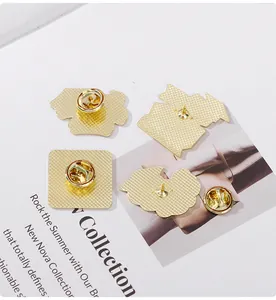 Macro view of golden plated metal badge pin butterfly clutch and needle back clasp details