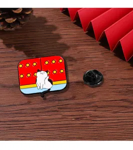 Detail of enamel cat badge with red palace gate design and black rubber clasp