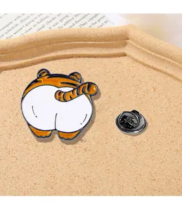 Detailed macro view of a cartoon tiger butt enamel pin with a black butterfly clutch