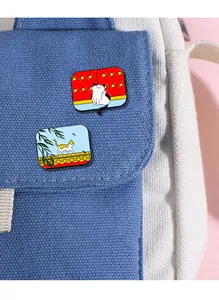 Detail of Chinese style enamel cat pins pinned on a canvas bag with traditional motifs